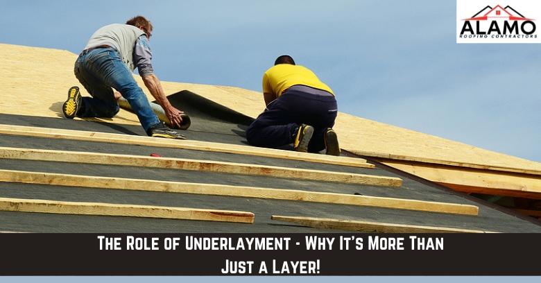 Two workers install roofing underlayment on a wooden roof structure under a clear sky, with a logo labeled Alamo Roofing Contractors in the top right corner.